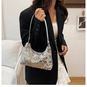 Detail of silver sequined crescent shoulder bag showing metallic reflective texture