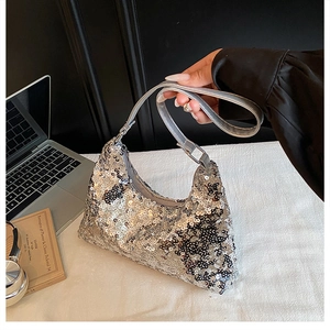 Detail of silver sequined hobo bag with sleek leather strap and metallic texture