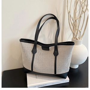 Detailed view of the canvas and leather trim tote bag with long handles for commuting