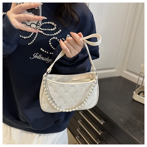 Detail of off-white quilted hobo bag featuring pearl chain strap and rhombus patterns