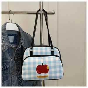 Close-up of blue gingham pouch with red apple print hanging on a metal hanger
