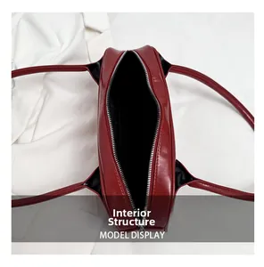 Top view of red baguette bag showing interior lining and silver zipper detail