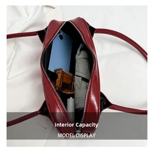 Top-down view of red leather baguette bag interior showing spacious storage for daily items