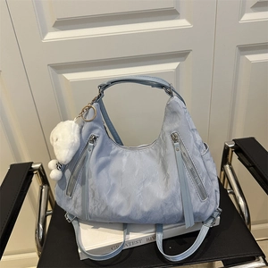 Light blue pleated multi-functional backpack and tote bag with plush dog charm