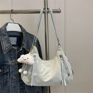 Fashionable beige hobo shoulder bag with metal zippers and a plush cloud charm