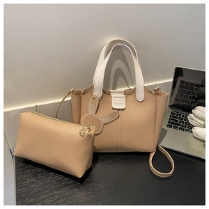 Close-up of khaki faux leather tote and matching pouch set with a cute bunny charm