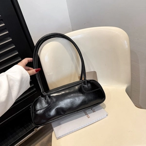 Fashionable black glossy leather baguette shoulder bag with vintage crinkled texture detail