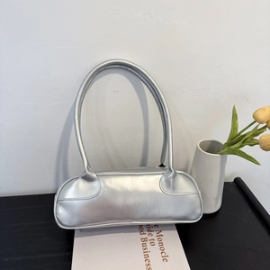 Chic metallic silver baguette bag shown from a top-down angle on a modern minimalist desk