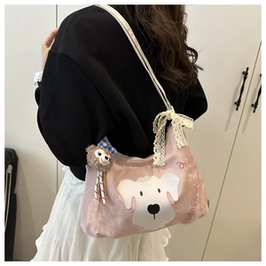 Detailed side view of pink canvas shoulder bag featuring puppy embroidery and lace bow
