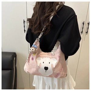 Detail of pink canvas crossbody bag featuring white dog embroidery and lace edges