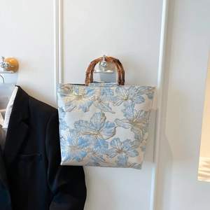 Elegant blue floral jacquard tote bag with natural bamboo handles for a vintage style