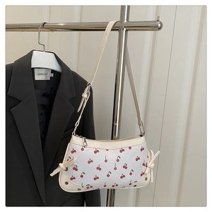Détail du sac d'épaule blanc à motif cerise avec nœuds et fermeture éclair