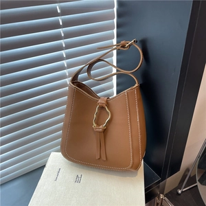 Brown PU leather shoulder bag with white stitching, gold ring buckle and fringe detail