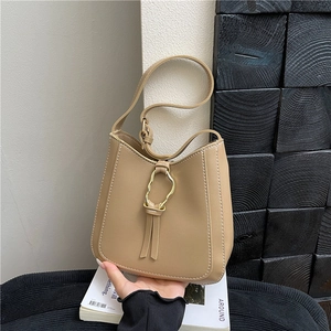 Minimalist khaki PU leather bucket bag with a unique gold irregular ring buckle