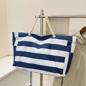 Large striped canvas tote beach bag with white rope handles for outdoor travel and shopping