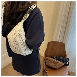 Close-up of bow knot corduroy waist bags with butterfly print and adjustable straps