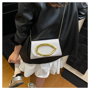 Detailed back view of model wearing white PU leather crossbody bag with gold chain strap