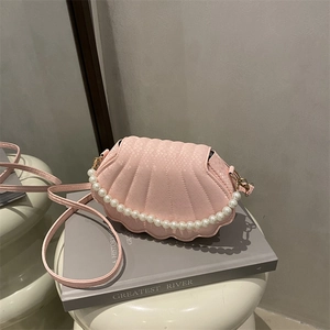 Pink shell-shaped crossbody bag with pearl chain handle and embossed snake skin texture