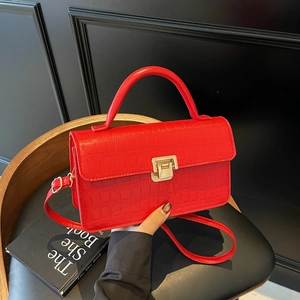 Elegant red crocodile pattern crossbody bag with a gold clasp and a top handle