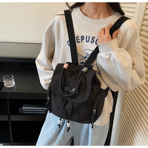 Detail of black nylon mini backpack with Ai Mi embroidery and drawstring flap