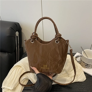 Luxury dark brown crinkled leather bucket bag with top handle and gold branding