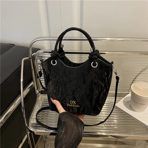 Chic black bucket bag with pleated texture and top handle for elegant shoulder carry