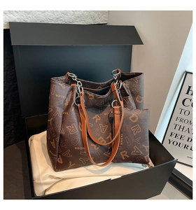 Detail shot of vintage coffee brown tote bag set with monogram print in premium gift box