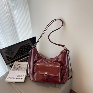 Retro burgundy faux leather hobo bag with adjustable strap and metallic buckle detail
