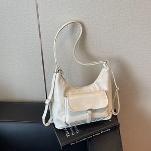 Elegant creamy white glossy patent leather tote bag with adjustable shoulder strap and front flap pocket