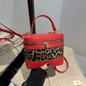 Red box-shaped shoulder bag with leopard print panel and golden zipper closure
