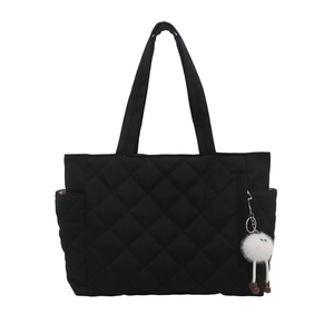 Black quilted tote bag with diamond pattern, side pockets and cute plush charm detail