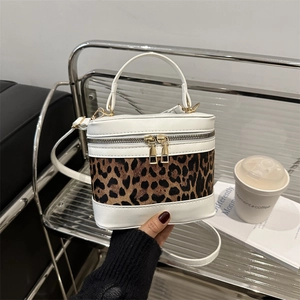 Leopard print patchwork cylinder crossbody bag with white leather and gold zippers