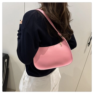 Detailed back view of model wearing a pink minimalist hobo bag with gold zipper