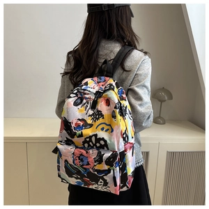 Detail of trendy nylon backpack featuring vibrant colorful abstract graffiti print for students