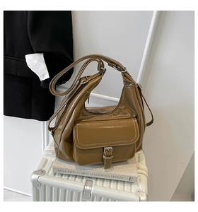 Detail view of caramel brown hobo bag with contrast stitching and buckle pocket