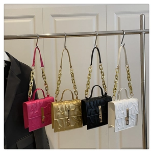 Macro detail of embossed leather handbags with chain straps in four different colors
