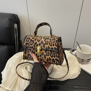 Leopard print crossbody bag with gold rotating lock and removable shoulder strap