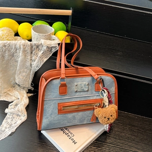 Vintage denim blue tote bag with orange leather trim and brown teddy bear charm