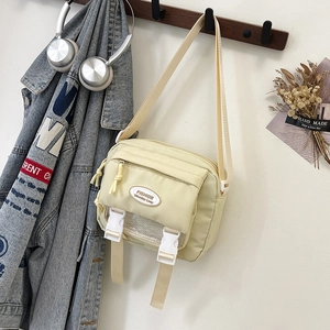 Japanese style yellow nylon messenger bag with front zipper and adjustable strap
