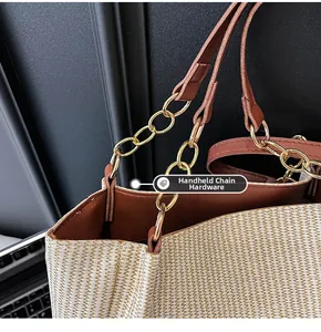 Close-up of golden hardware link connecting woven straw body to brown leather handles