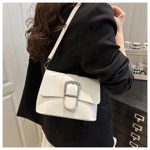 Close-up of white PU leather crossbody bag featuring a large silver metal buckle detail