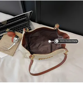 Internal structure of straw tote bag showing brown lining and zipper pocket detail