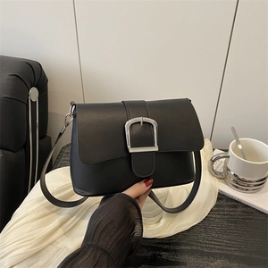 Minimalist black matte leather crossbody bag with oversized silver metal buckle