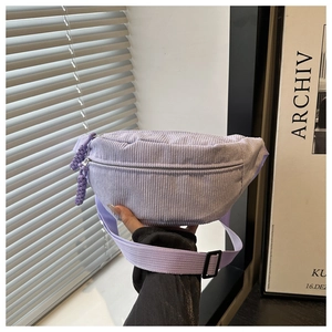 Detail of light purple corduroy crossbody bag with adjustable strap and metal zipper