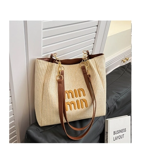 Detailed macro view of woven straw texture with leather strap and golden chain link