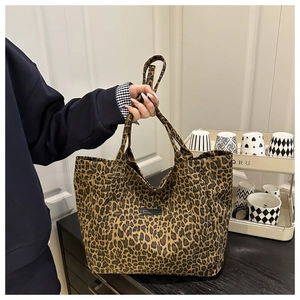Detail of leopard print tote bag with black label and durable woven canvas texture