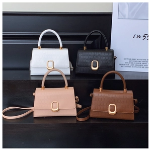Detail view of four-color baguette bags featuring crocodile pattern and gold oval locks