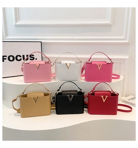 Detailed close-up showing six assorted colors of pebble grain leather crossbody handbags