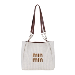 Minimalist cream woven tote bag with contrast brown leather straps and gold chain detail