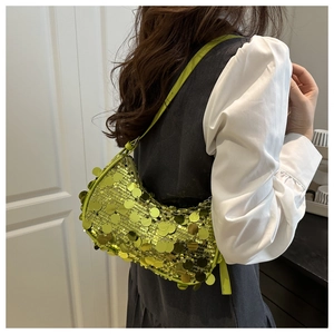 Detail of vibrant lime green sequin crescent bag with metallic luster and slim shoulder strap